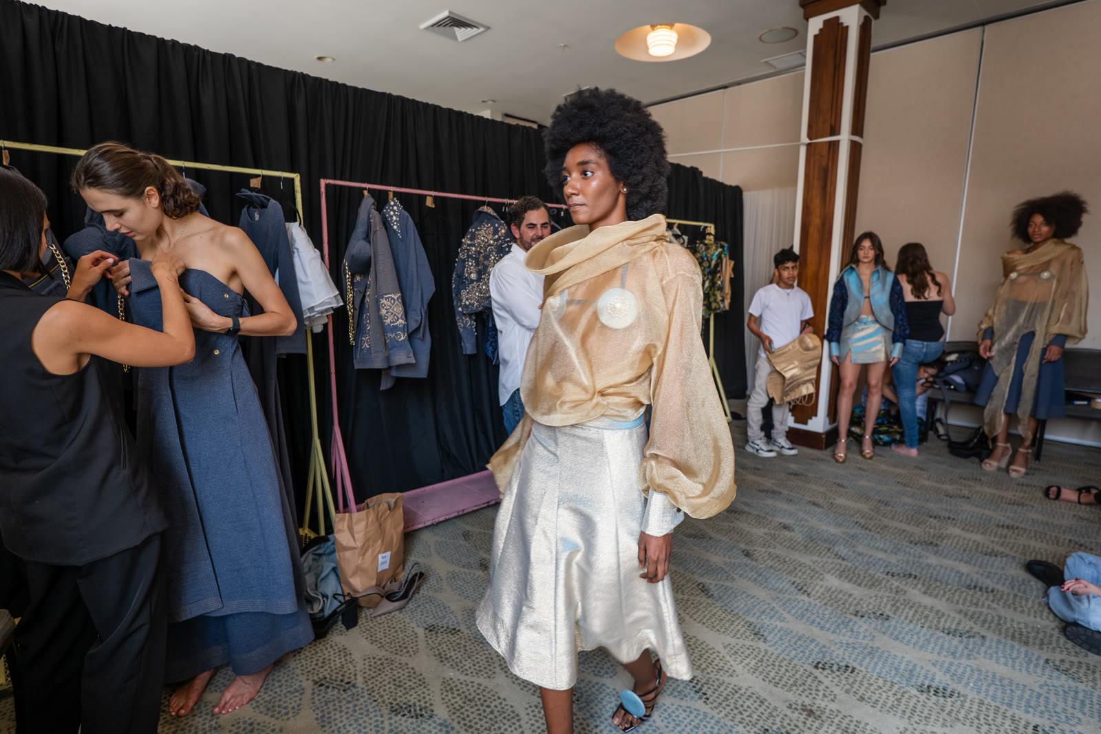 Backstage dressing room at Panama Fashion Week — models preparing for the Toribio & Donato show